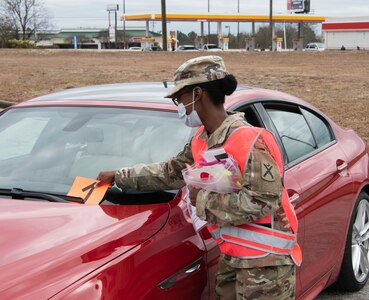 U.S. Army Spc. Tyasia Cobb, 218th Maneuver Enhancement Brigade, South Carolina National Guard, places a number on a patient’s vehicle at a COVID-19 mobile testing site in Lexington, South Carolina, Jan. 26, 2021. The South Carolina National Guard remains ready to support counties, state and local agencies and first responders as long as needed in support of COVID-19 response efforts.