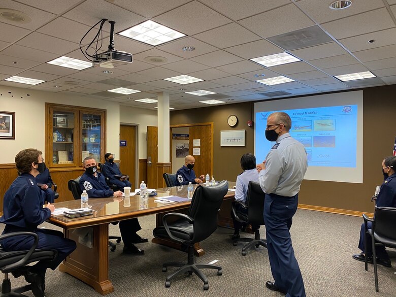 Gen. Jacqueline Van Ovost, Air Mobility Command commander, listens as Col. Greg Buchanan, 459th Air Refueling Wing commander, talks about the wing's mission, history, and priorities during her visit here, Jan. 25, 2021.