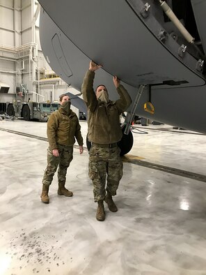 New kid on the block
445th Aircraft Maintenance Squadron Reserve Citizen Airmen Tech. Sgt. Jeremie Jamito trains new electrician, Amn. Jenna Gassawaysteere on opening and closing the doors of a C-17 Globemaster III aircraft Jan. 14, 2021.  Gassawaysteere was also taught hot to egress the jet in case of an emergency.