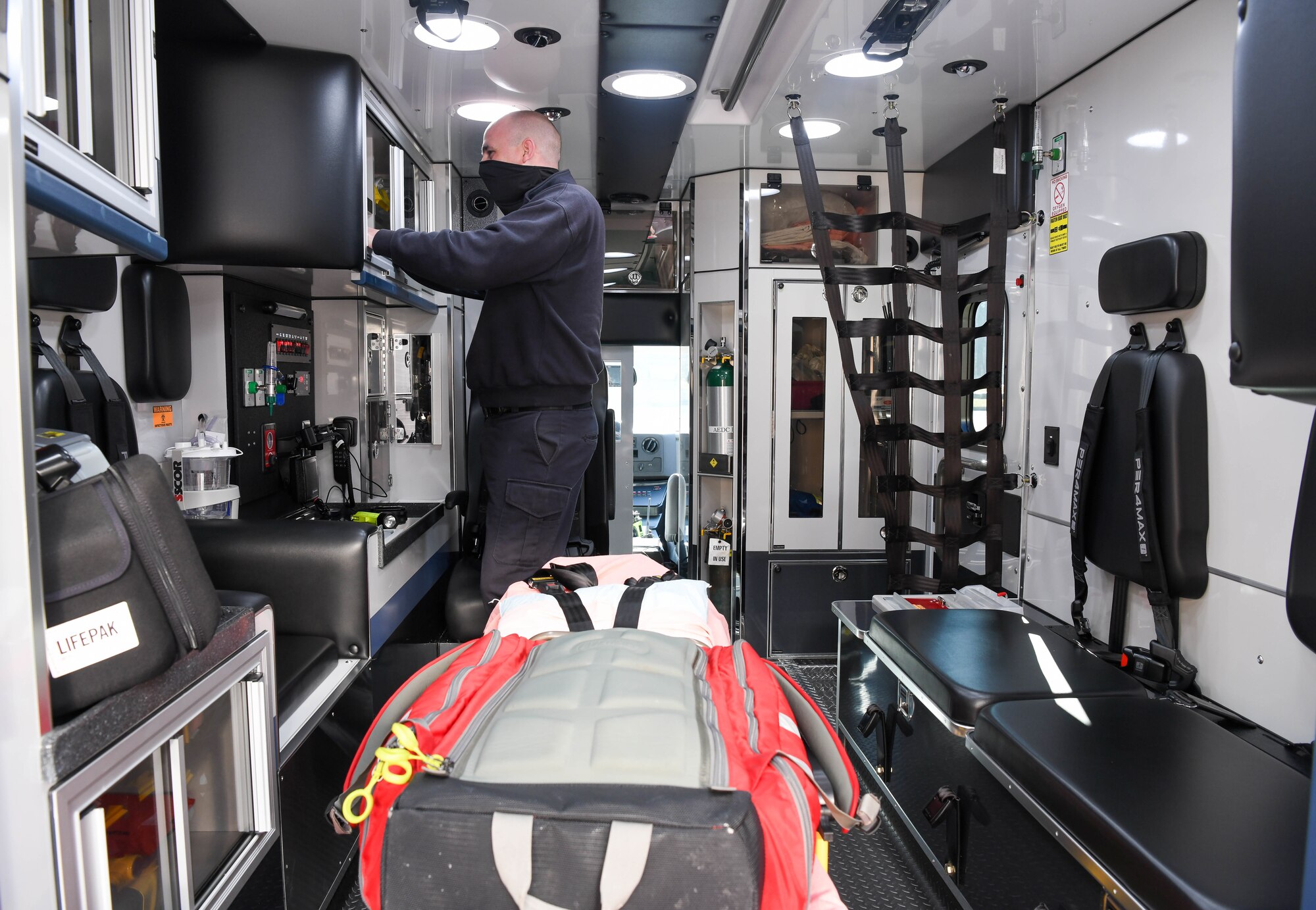 Joey Anderson, a firefighter/paramedic for Arnold Air Force Base Fire and Emergency Services, checks supplies in the FES team’s newly-acquired ambulance Jan. 12, 2021, Arnold AFB, Tenn. The cabinets inside the ambulance can be accessed by both sliding doors and swinging doors. (U.S. Air Force photo by Jill Pickett)