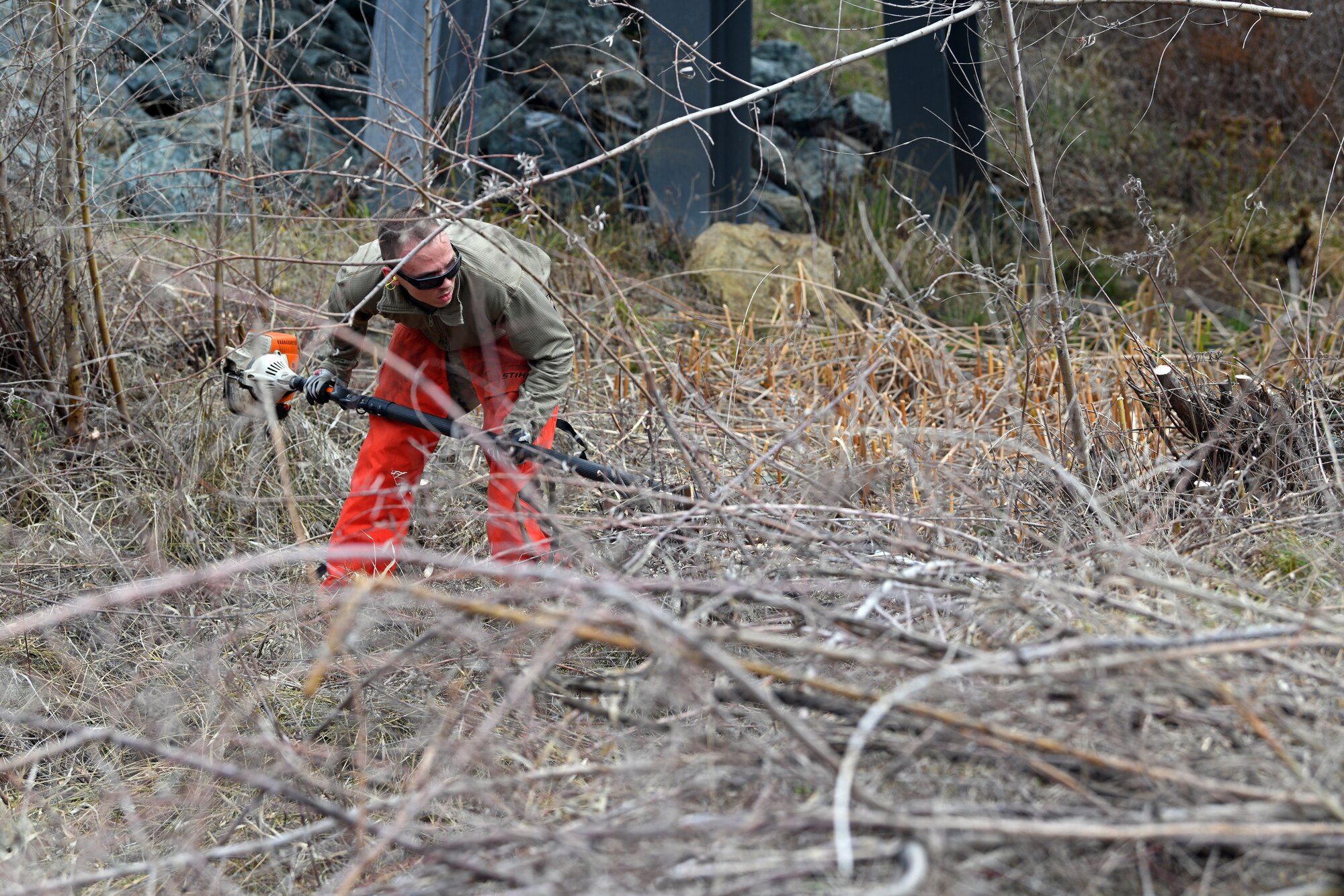 Airman 1st Class Jonathan Evett, 9th Civil Engineering Squadron pavement and construction equipment specialist, cuts down young trees growing on a ditch, Jan. 8, 2020, at Beale Air Force Base California. Recce Town’s pavement and construction Airmen are responsible for maintaining approximately 23,000 acres of land on Beale. (U.S. Air Force photo by Airman 1st Class Luis. A. Ruiz-Vazquez)