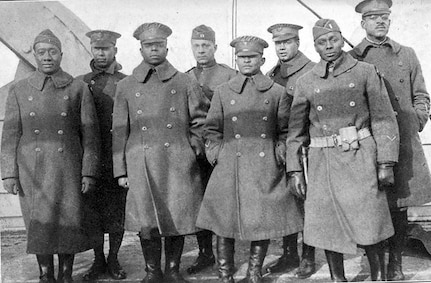 Officers of the 370th (Old 8th Illinois) on the deck of the La France IV before landing in New York City. From left are 2nd Lt. Lawson Price; 2nd Lt. L. W. Stearls; 2nd Lt. Ed. White; 2nd Lt. Eli F. E. Williams; 1st Lt. Oasola Browning; Capt. Louis B. Johnson; 1st Lt. Frank Bates; 1st Lt. Binga Desmond.