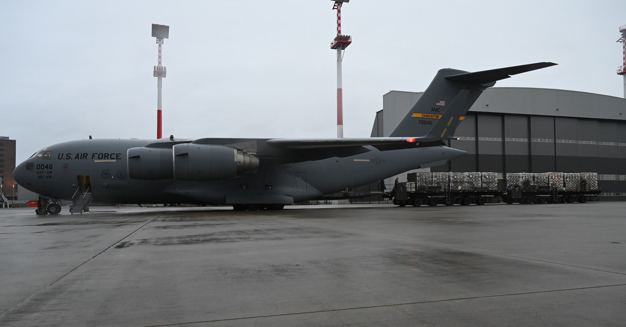A C-17 Globemaster III is unloaded at Ramstein Air Base, Germany, Feb. 2, 2021. More than 400,000 masks requested by the Defense Logistics Agency were delivered to Ramstein and unloaded by the 721st Aerial Port Squadron. The 721st APS plays an important role in the distribution of masks and other COVID-19 protective equipment.(U.S. Air Force photo by Senior Airman Thomas Karol)