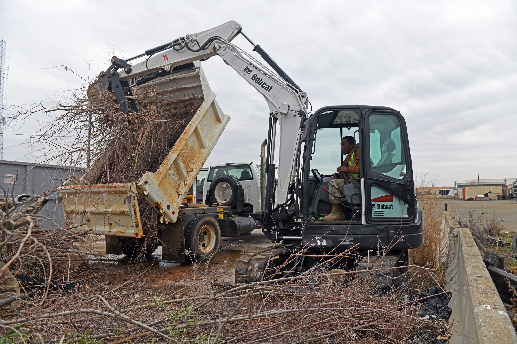 Senior Airman Diante Townsend, 9th Civil Engineering Squadron pavement and construction equipment specialist, uses heavy machinery to unload a dump truck, Jan. 8, 2020, at Beale Air Force Base, California. Pavement and construction equipment specialists are trained to operate and maintain a wide variety of heavy equipment, such as front-end loaders, bulldozers, dump trucks, and backhoes. (U.S. Air Force photo by Airman 1st Class Luis A. Ruiz-Vazquez)