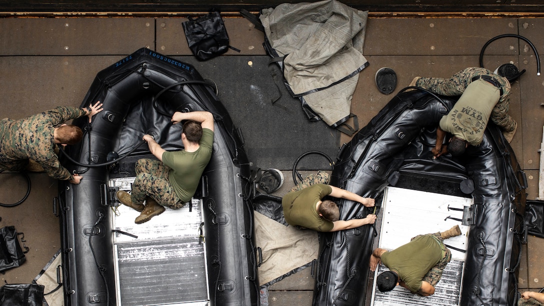 U.S. Marines build a Combat Rubber Raiding Craft aboard Whidbey Island-class dock landing ship USS Ashland (LSD 48), Jan. 18.