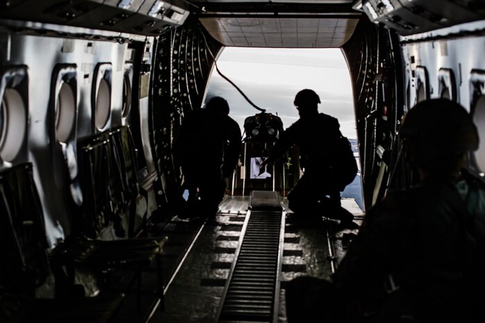 U.S. Marines send an ultra-lightweight Joint Precision Airdrop System out of the back of a CASA C-212 airplane on Camp Lejeune, N.C., Jan. 11.