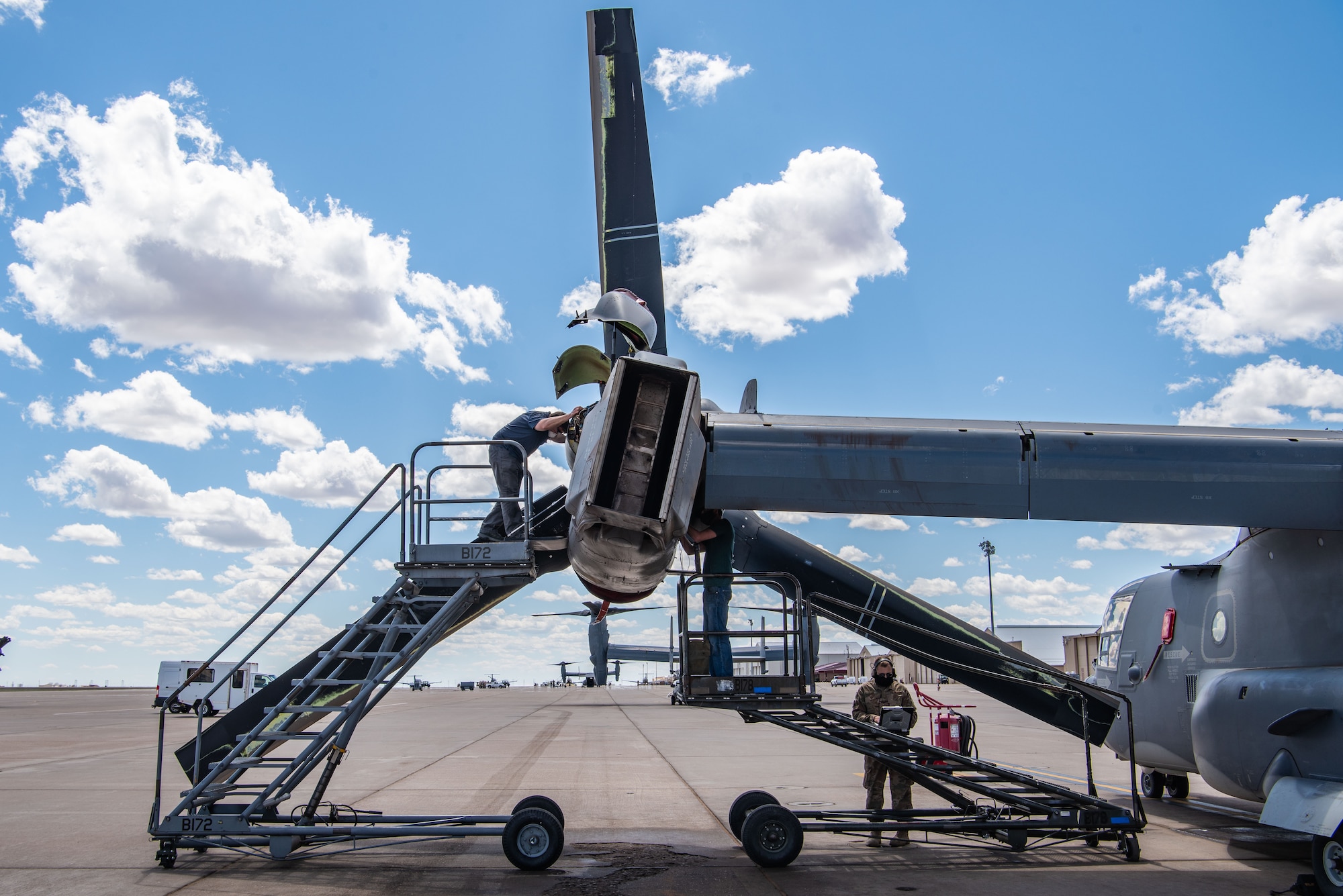An Airman works on the wing of a CV-22 Osprey