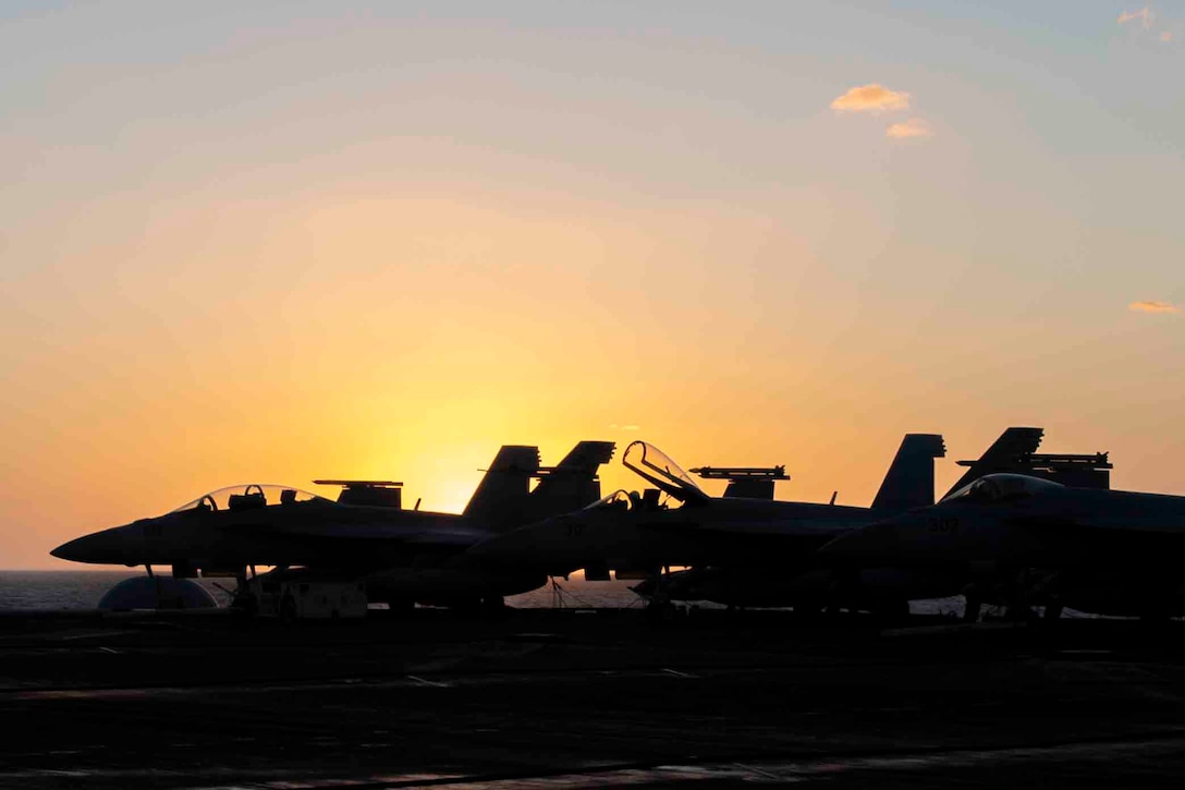 Plane silhouetted by the sun.