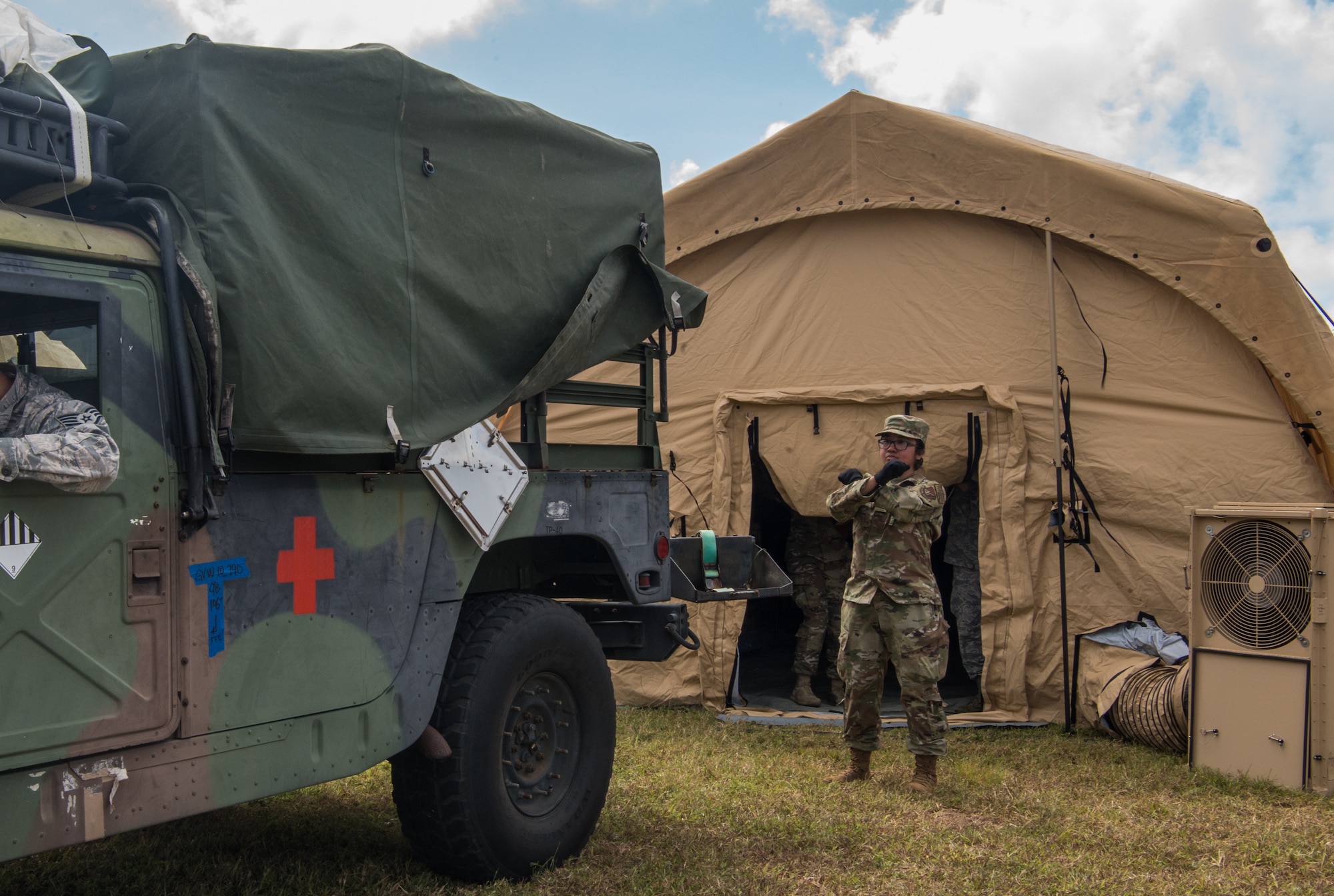 U.S. Air Force Staff Sgt. Christine Ebio assigned to the 18th Medical Group, Kadena Air Base, Japan, directs a Humvee for a patient transport during a Cope North 20 (CN20) mass casualty exercise at Rota, U.S. Commonwealth of the Northern Mariana Islands, Feb 20, 2020. Service members from the U.S., Royal Australian Air force, and Koku Jieitai (Japan Air Self-Defense Force) honed their Humanitarian Assistance and Disaster Relief (HADR) skills by providing emergency medical care for simulated patients. Cope North enhances U.S. relations with regional allies and partners by demonstrating resolve to promote security and stability throughout the Indo-Pacific. (U.S. Air Force photo by Staff Sgt. Curt Beach)