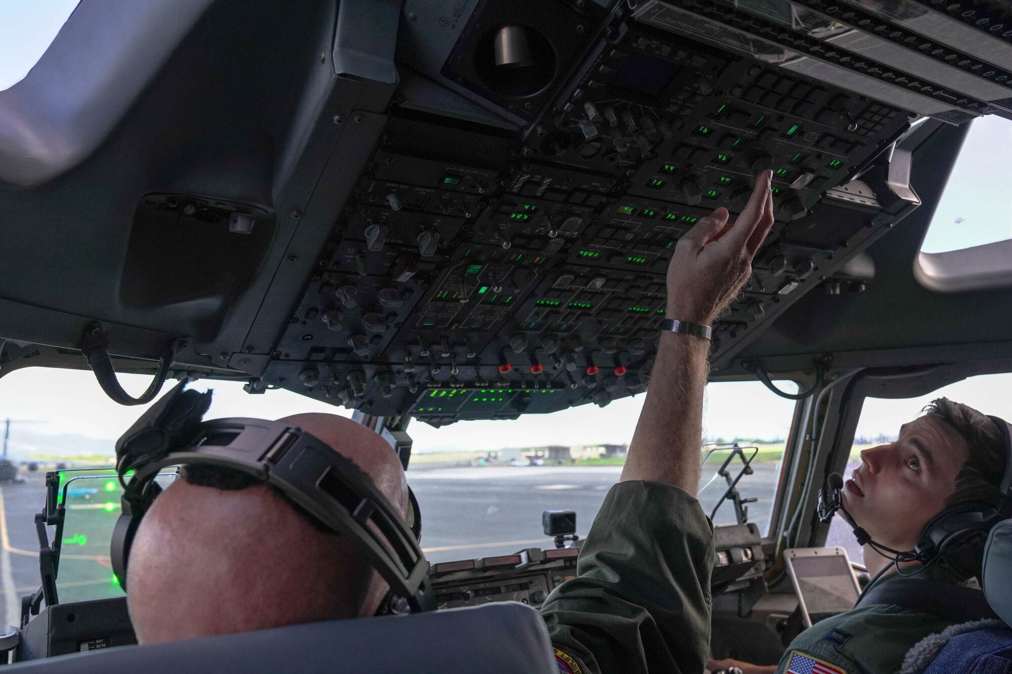 Lt. Col. Andrew Powers and Capt. Rocque Gartland, 535th Airlift Squadron instructor pilots prepare for take-off in the C-17 Globemaster on Joint Base Pearl Harbor Hickam, Hawaii, January 31, 2021. The Hula Bowl is an all-star classic game played in Honolulu, a tradition dating back to 1946.  (U.S. Air Force photo by Airman 1st Class Makensie Cooper)