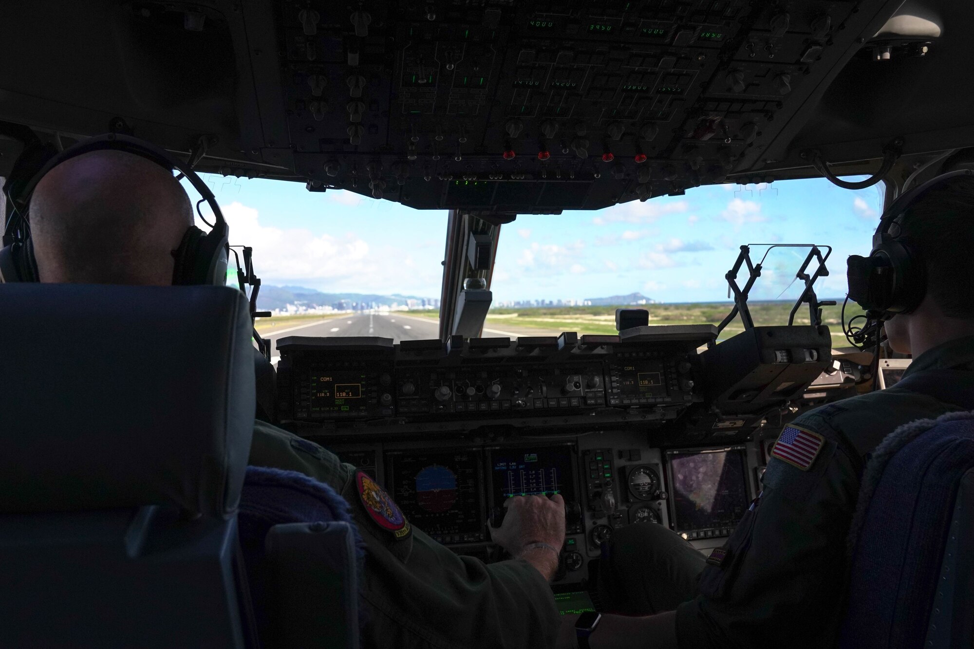 Lt. Col. Andrew Powers and Capt. Rocque Gartland, 535th Airlift Squadron instructor pilots prepare for take-off in the C-17 Globemaster on Joint Base Pearl Harbor Hickam, Hawaii, January 31, 2021. The Hula Bowl is an all-star classic game played in Honolulu, a tradition dating back to 1946.  (U.S. Air Force photo by Airman 1st Class Makensie Cooper)