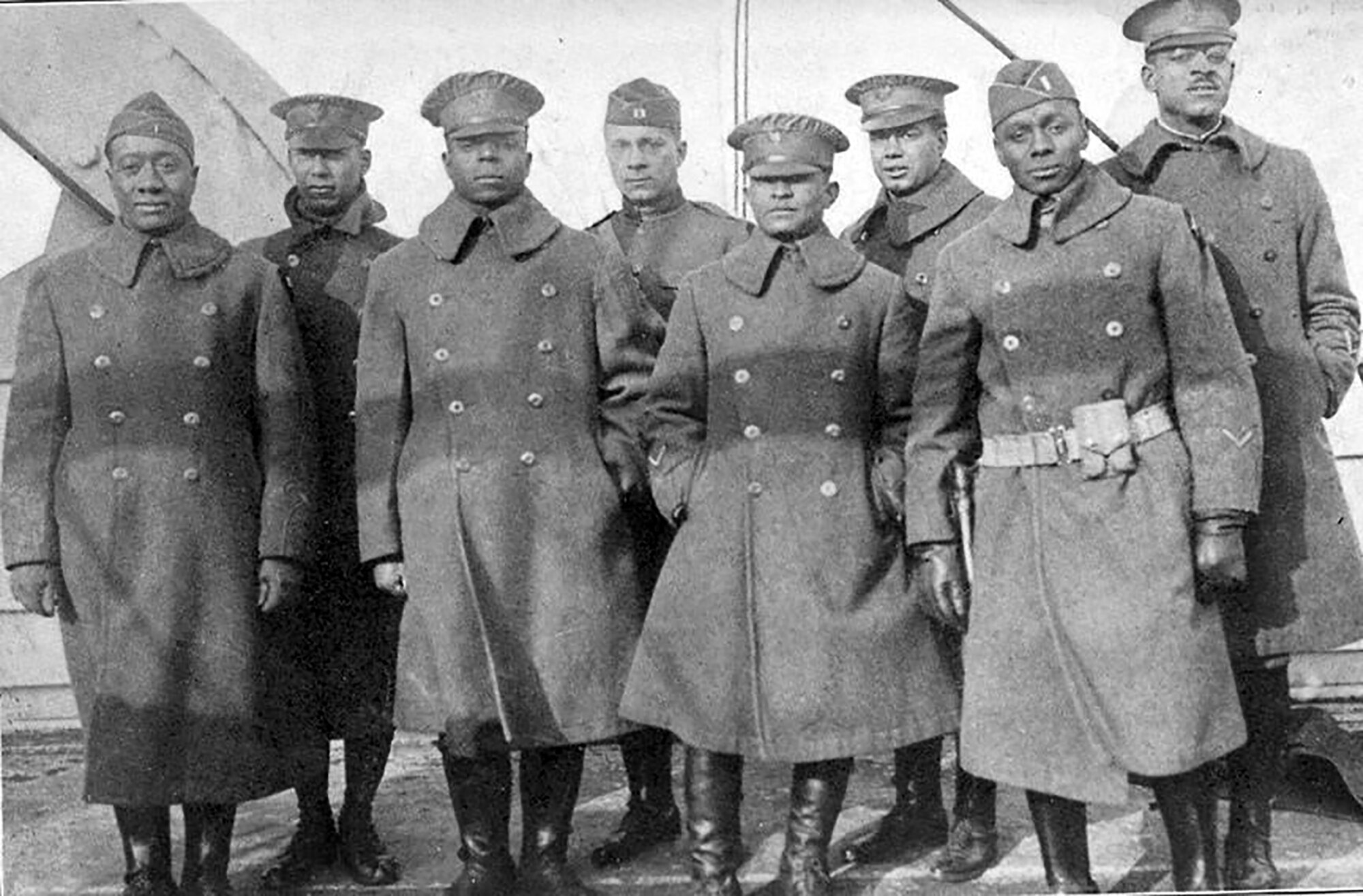 Officers of the 370th (Old 8th Illinois) on the deck of the La France IV before landing in New York City. From left are 2nd Lt. Lawson Price; 2nd Lt. L. W. Stearls; 2nd Lt. Ed. White; 2nd Lt. Eli F. E. Williams; 1st Lt. Oasola Browning; Capt. Louis B. Johnson; 1st Lt. Frank Bates; 1st Lt. Binga Desmond.