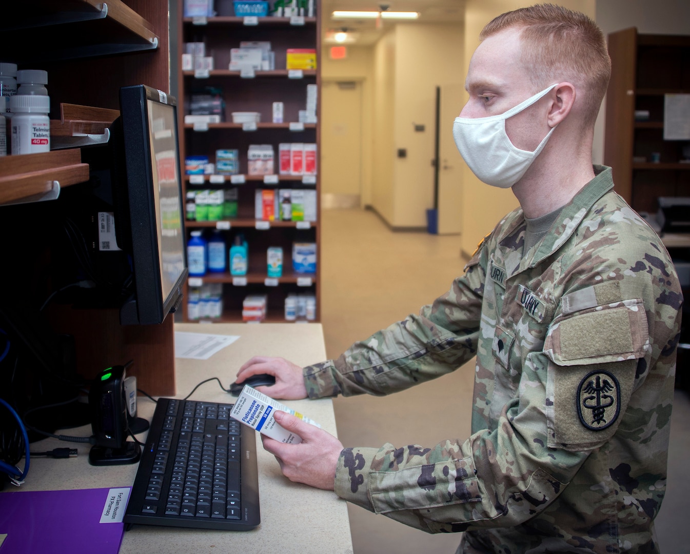 Army Spc. Trevor Osburn, pharmacy technician, fills prescriptions at the Community Pharmacy in the Exchange at Joint Base San Antonio-Fort Sam Houston Feb. 1. The Community Pharmacy fills an average of 330 new prescriptions and 1,440 refills daily.