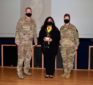 Col. Terry W. McClain, 433rd Airlift Wing commander, and Chief Master Sgt. Shana C. Cullum, 433rd AW command chief, stand to the sides of civilian category II winner, Nicole Garcia, 433rd Force Support Squadron, at the wing’s annual award recognition ceremony Jan. 30, 2021 at Joint Base San Antonio-Lackland, Texas. (U.S. Air Force photo by Airman 1st Class Brittany K. Wich)