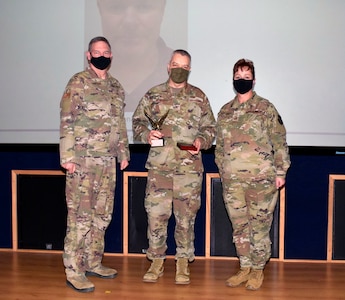 Col. Wayne M. Williams, 433rd Mission Support Group commander (center), accepts the civilian category III award from Col. Terry W. McClain, 433rd Airlift Wing commander, and Chief Master Sgt. Shana C. Cullum, 433rd AW command chief, on behalf of the winner, Donald M. Bowen, 433rd Civil Engineer Squadron, during the wing’s annual award recognition ceremony Jan. 30, 2021 at Joint Base San Antonio-Lackland, Texas. Bowen was unable to attend the ceremony. (U.S. Air Force photo by Airman 1st Class Brittany K. Wich)