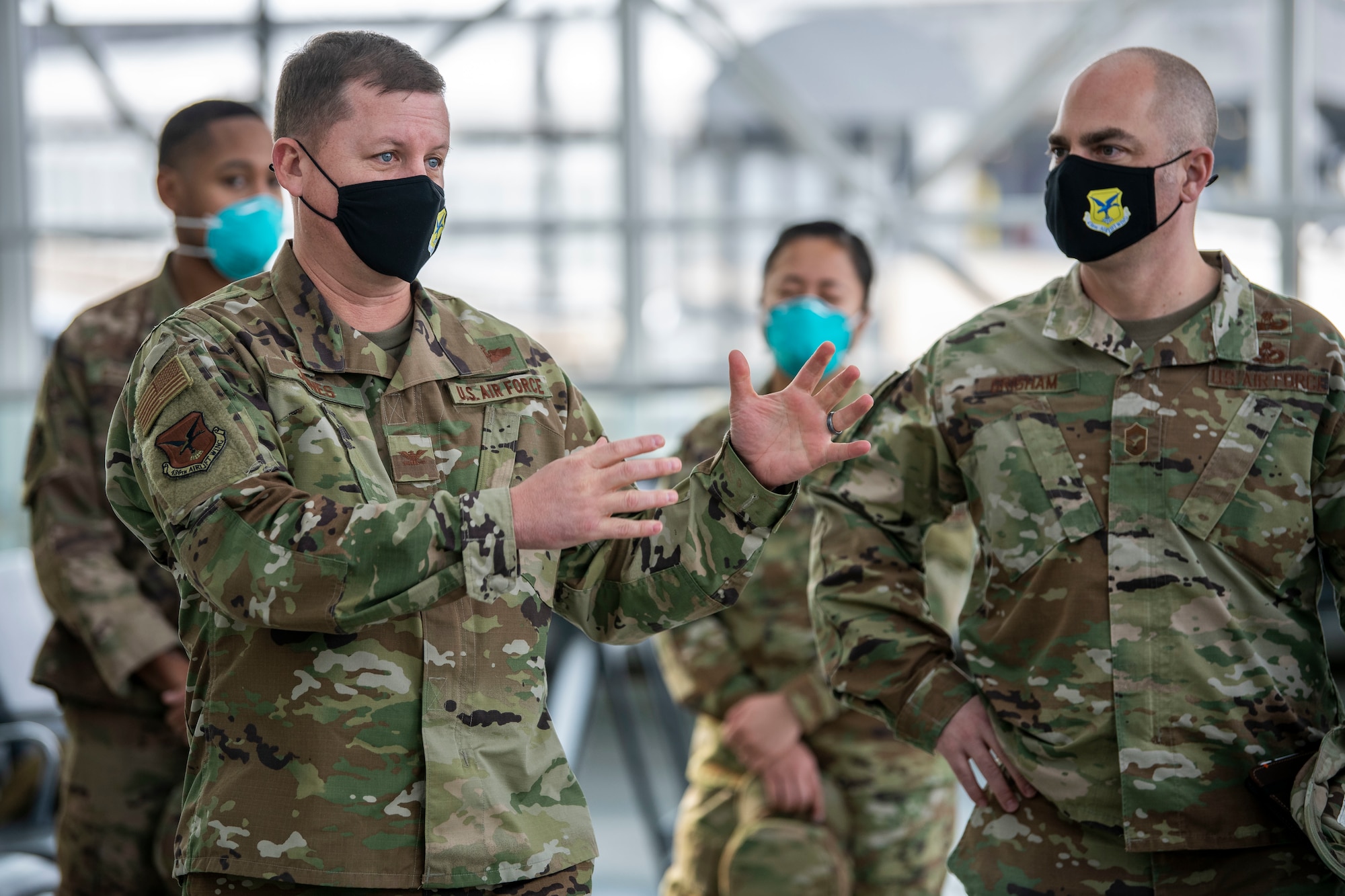 Col. Matthew Jones, 436th Airlift Wing commander, speaks with Airmen from the Patriot Express COVID-19 testing site at the Baltimore/Washington International Thurgood Marshall Airport in Baltimore, Maryland, Jan. 15, 2021. The site provides on-site rapid COVID-19 testing for service members and their families traveling to overseas duty locations. This operation helps ensure U.S. Transportation Command’s continued fulfillment of national security requirements while providing for the health and safety of service members, families and international partners. (U.S. Air Force photo by Senior Airman Christopher Quail)