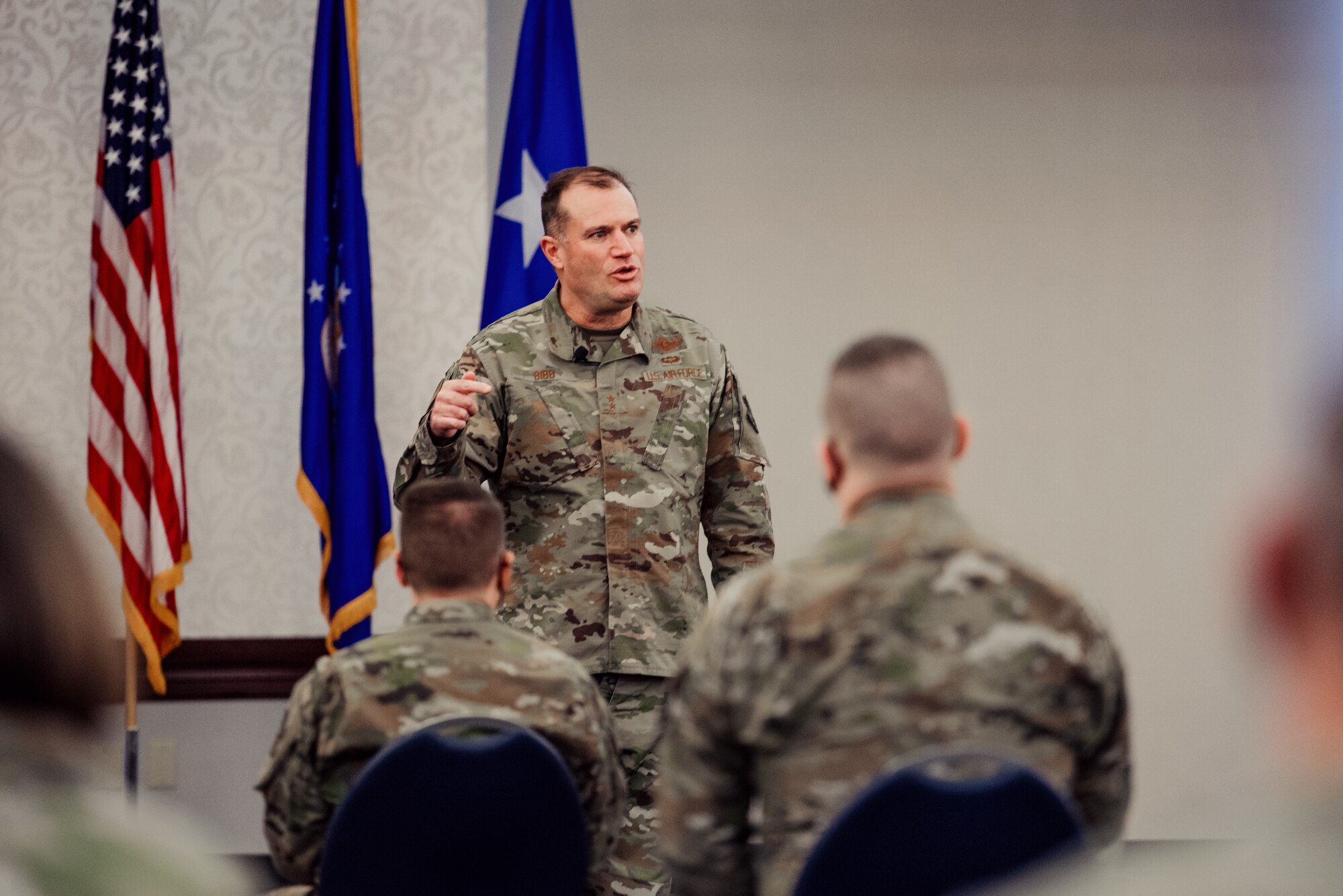 Man speaks to Airmen