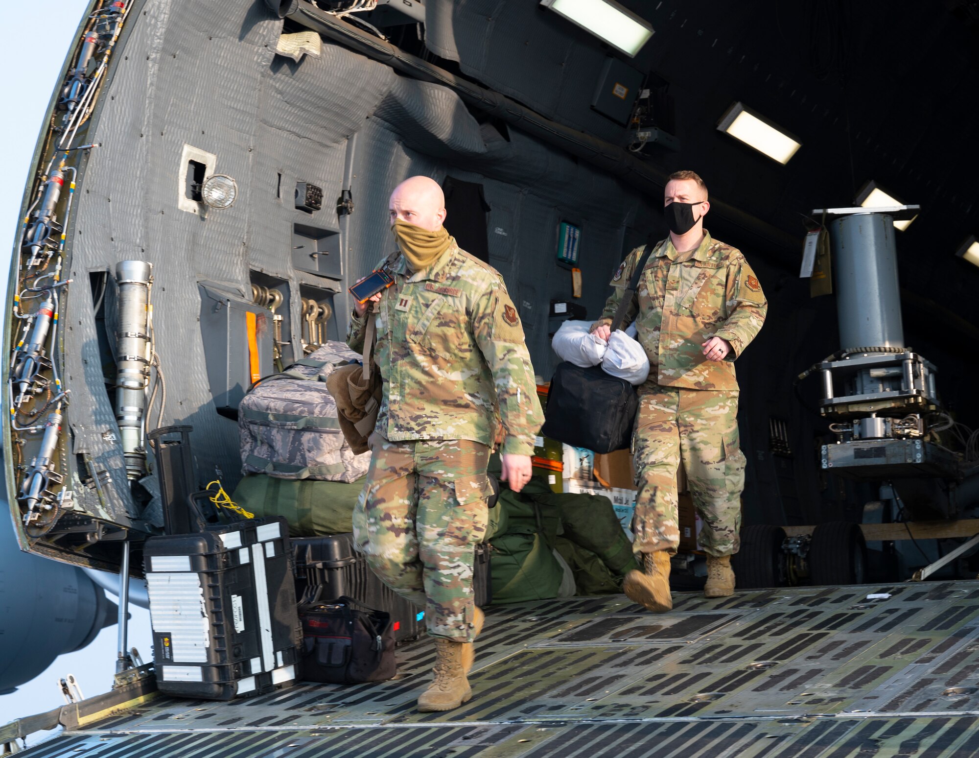 34th Expeditionary Bomb Squadron Airmen depart a C-5M Super Galaxy after a multi-day flight from Ellsworth Air Force Base, S.D., at Kempegowda International Airport in Bengaluru, India, Feb. 1, 2021. Approximately 50 Airmen traveled from Ellsworth AFB to Bengaluru in support of the B-1B Lancer’s participation in Aero India 2021. Aero India is the largest trade show in the Indo-Pacific, attracting a large number of exhibitors from around the world, with a large number of Department of Defense leadership in attendance.  (U.S. Air Force photo by Senior Airman Christina Bennett)