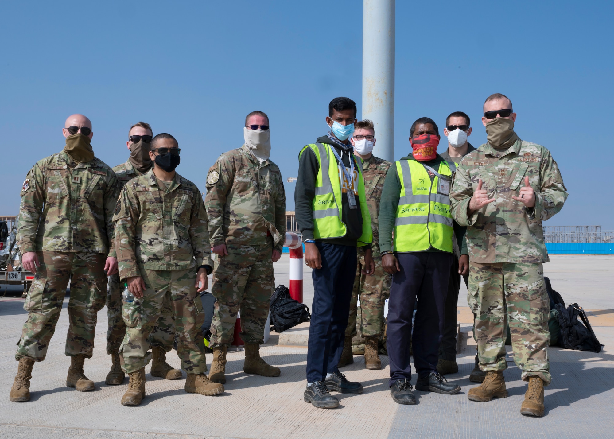 Airmen assigned to the 34th Expeditionary Bomb Squadron, Ellsworth Air Force Base, S.D., pose alongside Indian airfield operations specialists at Kempegowda International Airport in Bengaluru, India, Feb. 1, 2021. The 34th EBS is in India to support the B-1’s participation in Aero India 2021. Aero India provides the opportunity to build a stronger relationship between the United States and India, as well as with the international community. (U.S. Air Force photo by Senior Airman Christina Bennett)