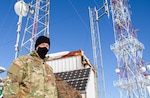 Chief Warrant Officer 2 John Finken, a contracting officer representative with Regional Command-East, Kosovo Force, inspects contractors performing maintenance during a radio systems inspection at Mount Golesh in Kosovo Jan. 28, 2021. During the inspection, the contractors check voltage on batteries, test transmitting power and perform other maintenance checks to ensure radio communication can be maintained.