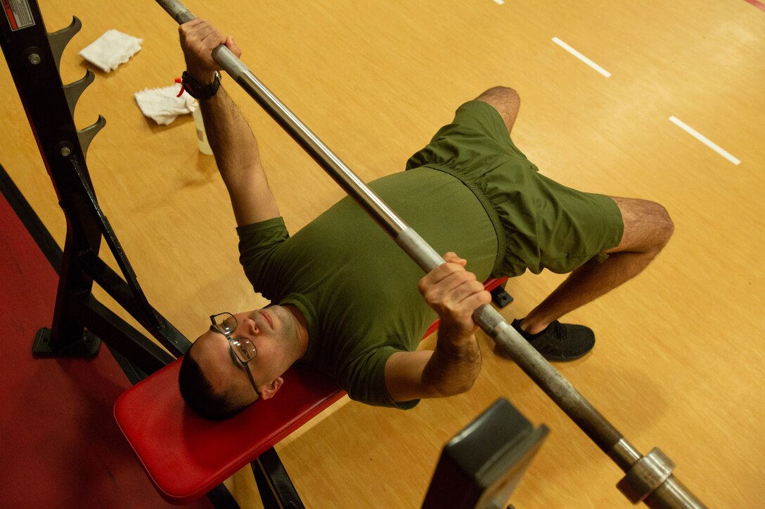 U.S. Marine Corps Sgt. Ezequiel Velazquez, an Intelligence Analyst with U.S. Marine Corps Forces Command, Fleet Marine Force Atlantic, executes a bench press with the proper posture during a High Intensity Tactical Training (HITT) course in the Hopkins Gymnasium on Camp Elmore, Norfolk, Virginia, January 27, 2021. HITT is a comprehensive strength and conditioning program that focuses on maintaining and improving physical resiliency and combat readiness. The Marines that progressed through the course will be a knowledgeable resource for physical training (PT) and will be able to conduct PT properly within their respective units. (U.S. Marine Corps Photo by Lance Cpl. Jack Chen/released)