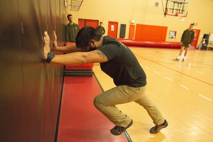 Mr. Allen Sese, the High Intensity Tactical Training (HITT) Coordinator for U.S. Marine Corps Forces Command, Headquarters and Service Battalion, demonstrates a workout during a HITT course in the Hopkins Gymnasium on Camp Elmore, Norfolk, Virginia, January 27, 2021. HITT is a comprehensive strength and conditioning program that focuses on maintaining and improving physical resiliency and combat readiness. The Marines that progressed through the course will be a knowledgeable resource for physical training (PT) and will be able to conduct PT properly within their respective units. (U.S. Marine Corps Photo by Lance Cpl. Jack Chen/released)