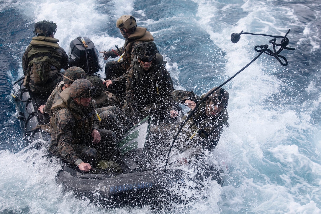 A U.S. Marine throws a line aboard dock landing ship USS Ashland (LSD 48), Jan. 28.