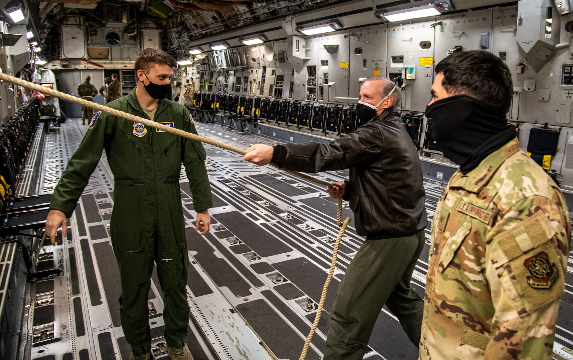 Col. John Rockwell, 436th Medical Group aerospace medicine chief, tests an emergency egress rope with Staff Sgt. Craig Tocci, 3rd Airlift Squadron loadmaster, and Technical Sgt. Jose Cardoza, 3rd AS loadmaster, on a C-17 Globemaster III at Dover Air Force Base, Delaware, Jan. 28, 2021. Emergency egress is a training requirement for all aircrew members. The 3rd AS routinely trains to support global engagement through direct delivery of time-critical theater deployment assets and ensure aircrew operational readiness. (U.S. Air Force photo by Airman 1st Class Faith Schaefer)