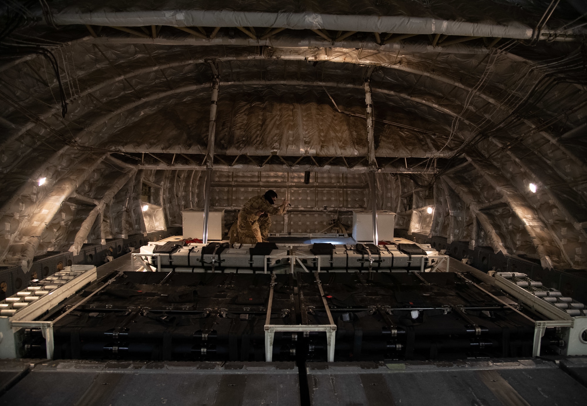 Technical Sgt. Jose Cardoza, 3rd Airlift Squadron loadmaster, performs a preflight inspection aboard a C-17 Globemaster III before a training sortie at Dover Air Force Base, Delaware, Jan. 28, 2021. Night missions serve to ensure aircrew effectiveness and readiness in contested and challenging environments. The 3rd AS routinely trains to support global engagement through direct delivery of time-critical theater deployment assets and ensure aircrew operational readiness. (U.S. Air Force photo by Airman 1st Class Faith Schaefer)