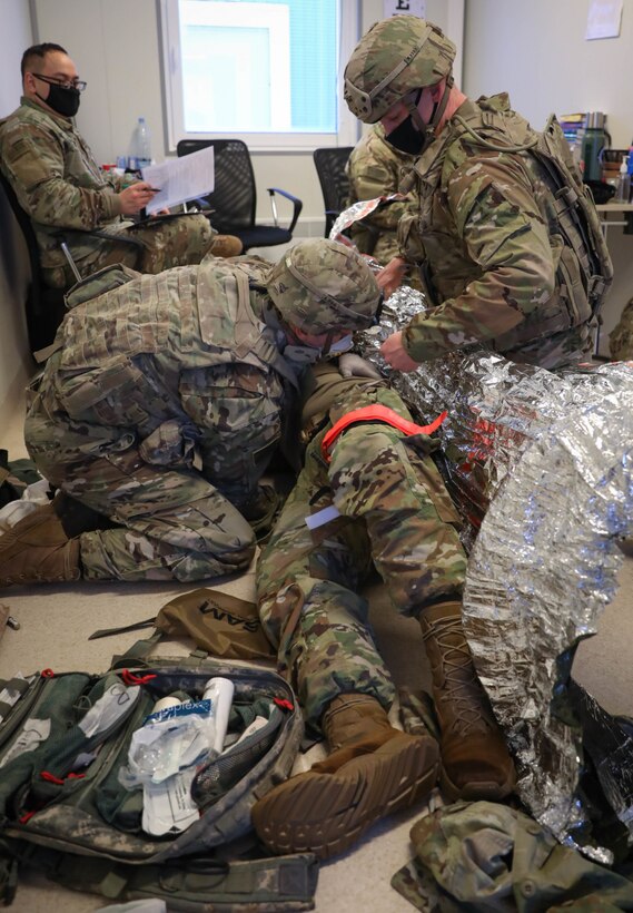 Combat medic specialists assigned to 2nd Battalion, 8th Cavalry Regiment, treat a simulated battlefield casualty during a Jan. 30, 2021, Tactical Combat Casualty Care assessment at the Pabrade Training Area, Lithuania. Participating in the assessment will strengthen and skills needed to help save a life on a battlefield.