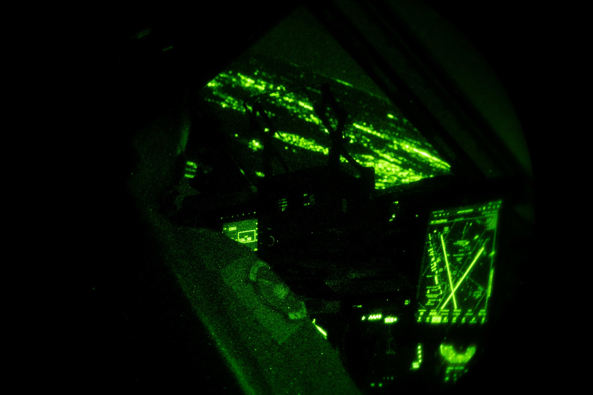 Capt. Corey Landis, 3rd Airlift Squadron instructor pilot, prepares to land a C-17 Globemaster III, while wearing night vision goggles at Dover Air Force Base, Delaware, Jan. 28, 2021. In combat, flying at night without artificial light minimizes visibility of the aircraft and reduces threat from potential enemies. The 3rd AS routinely trains to support global engagement through direct delivery of time-critical theater deployment assets and ensure aircrew operational readiness. (U.S. Air Force photo by Airman 1st Class Faith Schaefer)