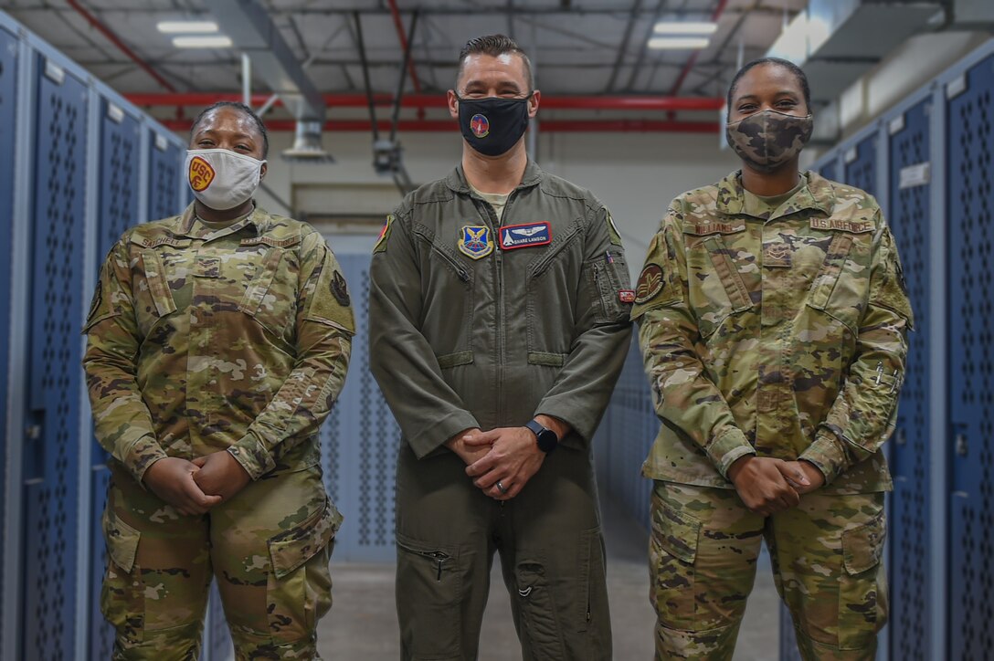 Airman First Class Keyannah Satchell, left, Captain Manuel Lamson, middle, Airman First Class Johnequa Williams, right, pose for a photo at the 7th Operations Group, Dyess Air Force Base, Texas, January 3, 2021. The Airmen created a Facebook page to help enlisted members learn more information about becoming an officer. (U.S. Air Force photo by Airman 1st Class Josiah Brown)
