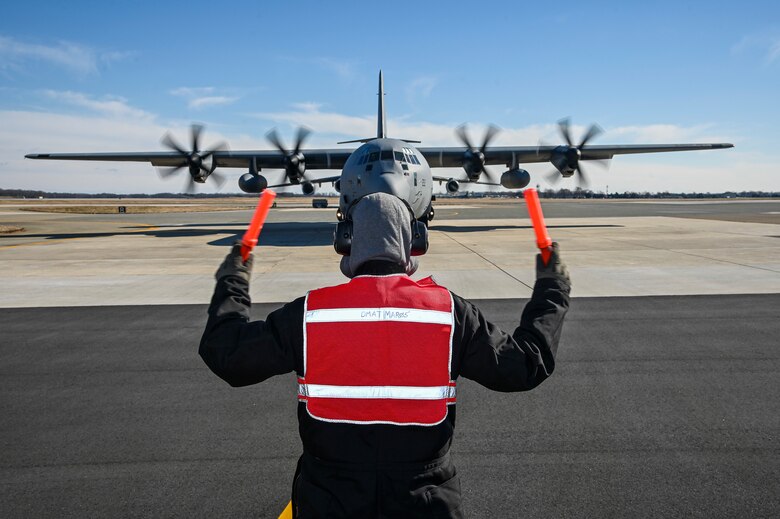 Robert Kelledes, 436th Maintenance Squadron work leader, marshals a Tunisian air force C-130J Super Hercules as part of a foreign military sales mission at Dover Air Force Base, Delaware, Jan. 28, 2021. The U.S. was the first major power to recognize Tunisian sovereignty and established relations with Tunisia in 1956 following its independence from France. Since then, Tunisia has become an even more critical partner and a major non-NATO ally, which entails military and economic privileges and is a powerful symbol of the close relationship between the U.S. and Tunisia. Due to its strategic geographic location, Dover AFB supports approximately $3.5 billion worth of FMS operations annually. (U.S. Air Force photo by Senior Airman Christopher Quail)