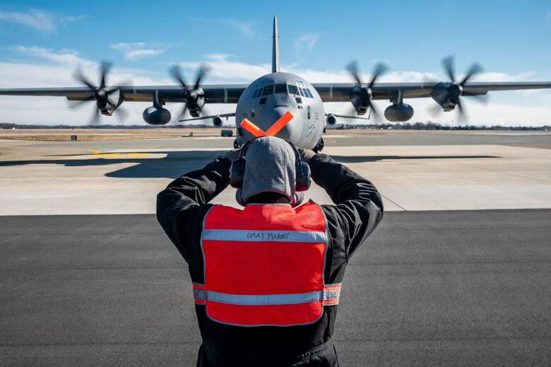 Robert Kelledes, 436th Maintenance Squadron work leader, marshals a Tunisian air force C-130J Super Hercules as part of a foreign military sales mission at Dover Air Force Base, Delaware, Jan. 28, 2021. The U.S. was the first major power to recognize Tunisian sovereignty and established relations with Tunisia in 1956 following its independence from France. Since then, Tunisia has become an even more critical partner and a major non-NATO ally, which entails military and economic privileges and is a powerful symbol of the close relationship between the U.S. and Tunisia. Due to its strategic geographic location, Dover AFB supports approximately $3.5 billion worth of FMS operations annually. (U.S. Air Force photo by Senior Airman Christopher Quail)