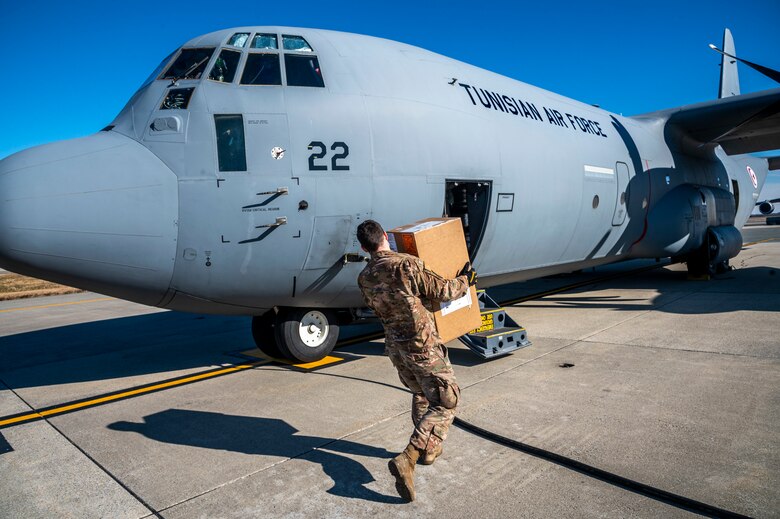 Staff Sgt. Deric Sexton, 436th Aerial Port Squadron load planner, delivers foreign military sales cargo to a Tunisian air force C-130J Super Hercules at Dover Air Force Base, Delaware, Jan. 28, 2021. The U.S. and Tunisia have enjoyed strong diplomatic relations for over 200 years, a special bond first enshrined when the two countries signed the Treaty of Peace and Friendship in 1797. Tunisia was among the first to recognize the newly independent U.S. during that time. Due to its strategic geographic location, Dover AFB supports approximately $3.5 billion worth of FMS operations annually. (U.S. Air Force photo by Senior Airman Christopher Quail)