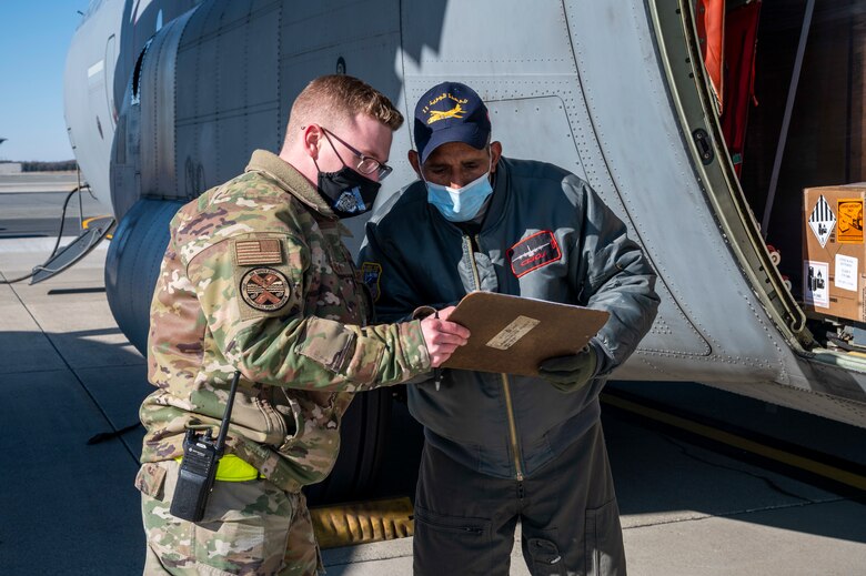 Airman 1st Class Kalub Kersey, 436th Aerial Port Squadron special cargo processor, and a Tunisian air force airman review a document during a foreign military sales mission at Dover Air Force Base, Delaware, Jan. 28, 2021. The U.S. was the first major power to recognize Tunisian sovereignty and established relations with Tunisia in 1956 following its independence from France. Since then, Tunisia has become an even more critical partner and a major non-NATO ally, which entails military and economic privileges and is a powerful symbol of the close relationship between the U.S. and Tunisia. Due to its strategic geographic location, Dover AFB supports approximately $3.5 billion worth of FMS operations annually. (U.S. Air Force photo by Senior Airman Christopher Quail) (This image was altered for security purposes by blurring identification on cargo)
