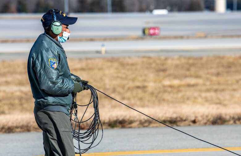 A Tunisian air force airman prepares a Tunisian air force C-130J Super Hercules for takeoff after completing a foreign military sales mission at Dover Air Force Base, Delaware, Jan. 28, 2021. The U.S. was the first major power to recognize Tunisian sovereignty and established relations with Tunisia in 1956 following its independence from France. Since then, Tunisia has become an even more critical partner and a major non-NATO ally, which entails military and economic privileges and is a powerful symbol of the close relationship between the U.S. and Tunisia. Due to its strategic geographic location, Dover AFB supports approximately $3.5 billion worth of FMS operations annually. (U.S. Air Force photo by Senior Airman Christopher Quail)