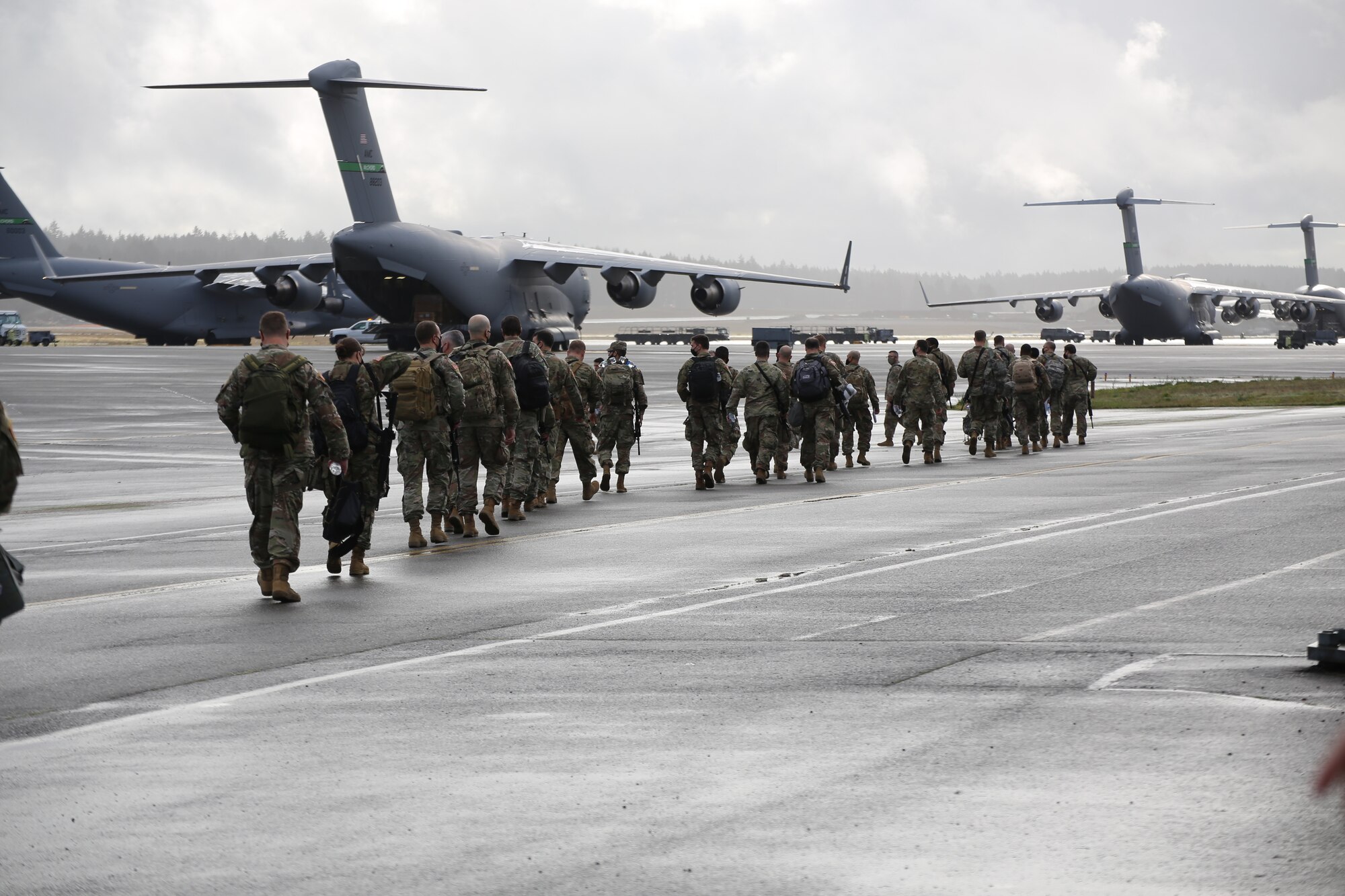 Guardsmen walk to an awaiting KC-135 aircraft