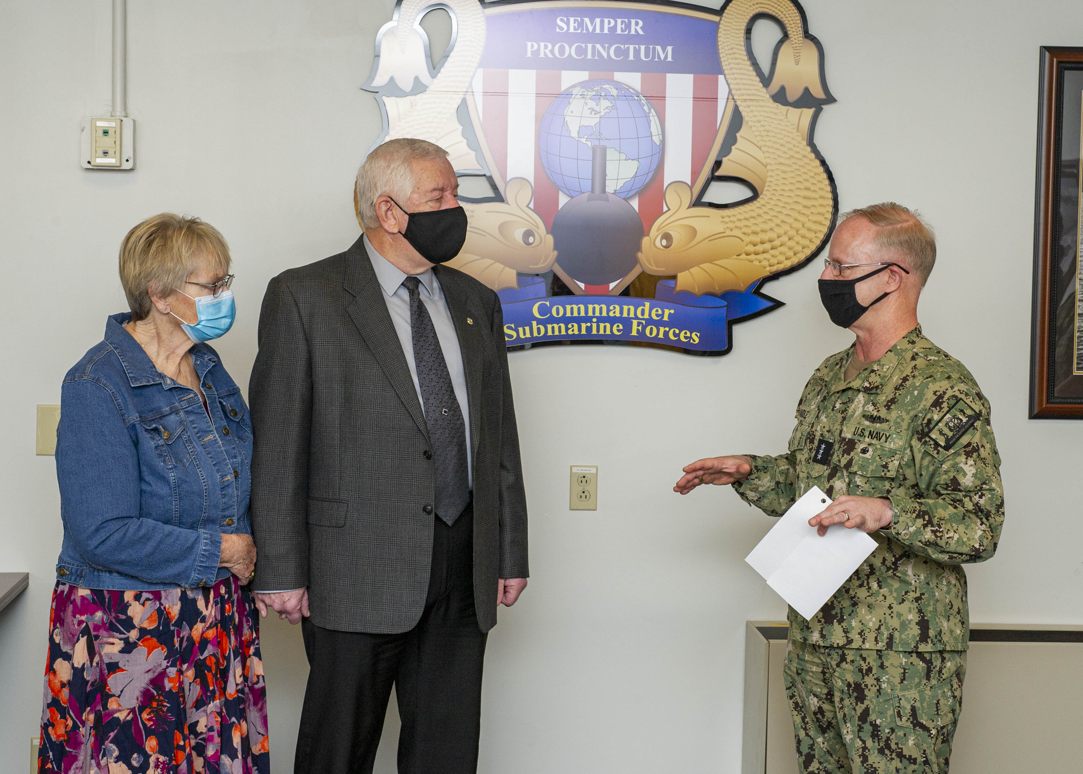 Robert Tayman, middle, ordnance logistics management specialist at Submarine Forces Atlantic (SUBLANT), and his wife, Anne, listen as Vice Adm. Daryl Caudle, commander, Submarine Forces, talks during a civilian of the year award ceremony.