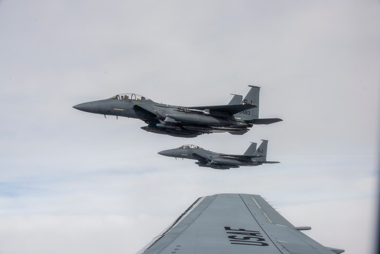 F-15E Strike Eagles from the 334th Fighter Squadron at Seymour Johnson Air Force Base, are guided by a KC-46A Pegasus, as they wait to be refueled on Jan. 21, 2021.