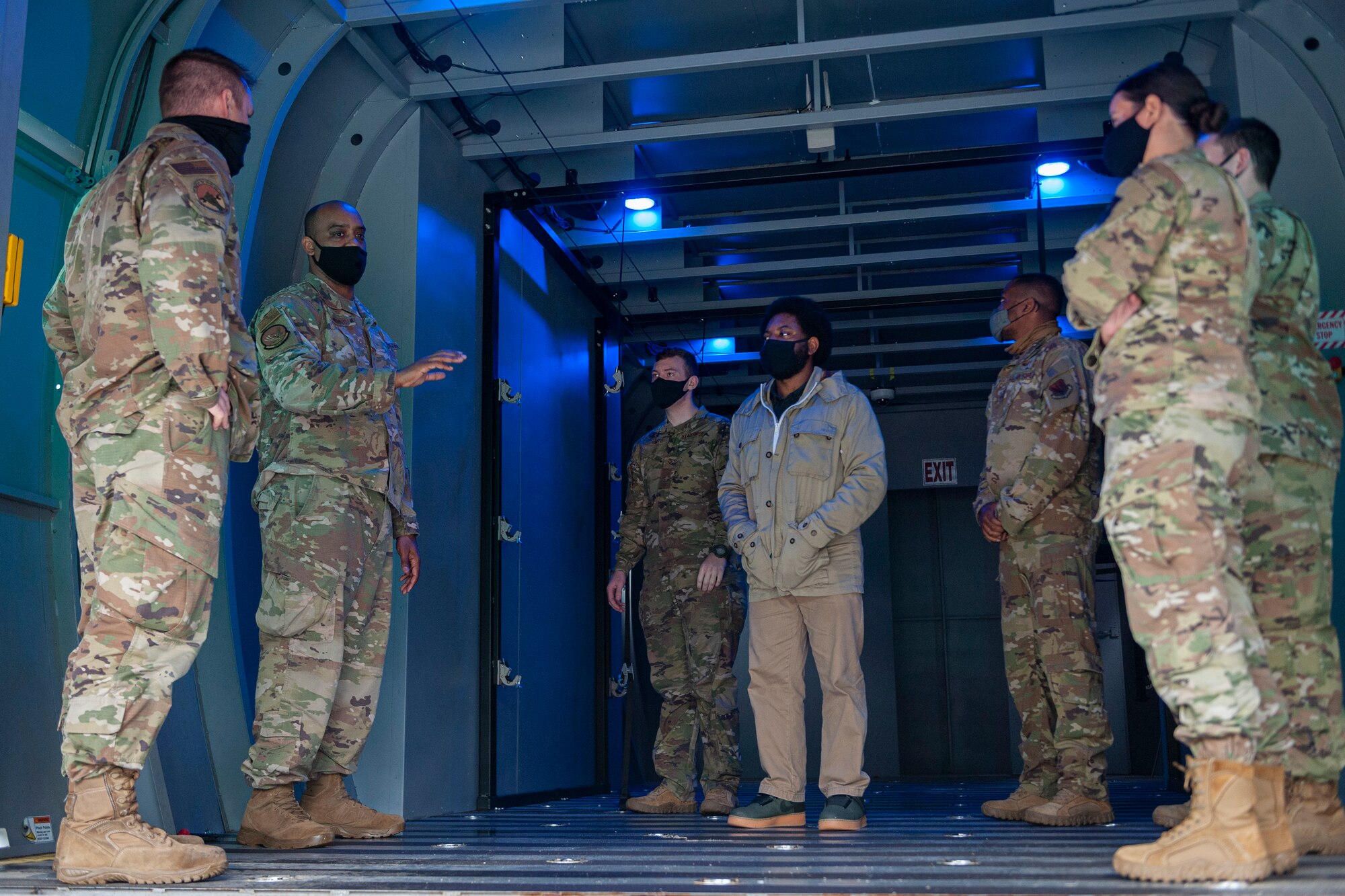 Photo of an Airman explaining patient transportation procedures