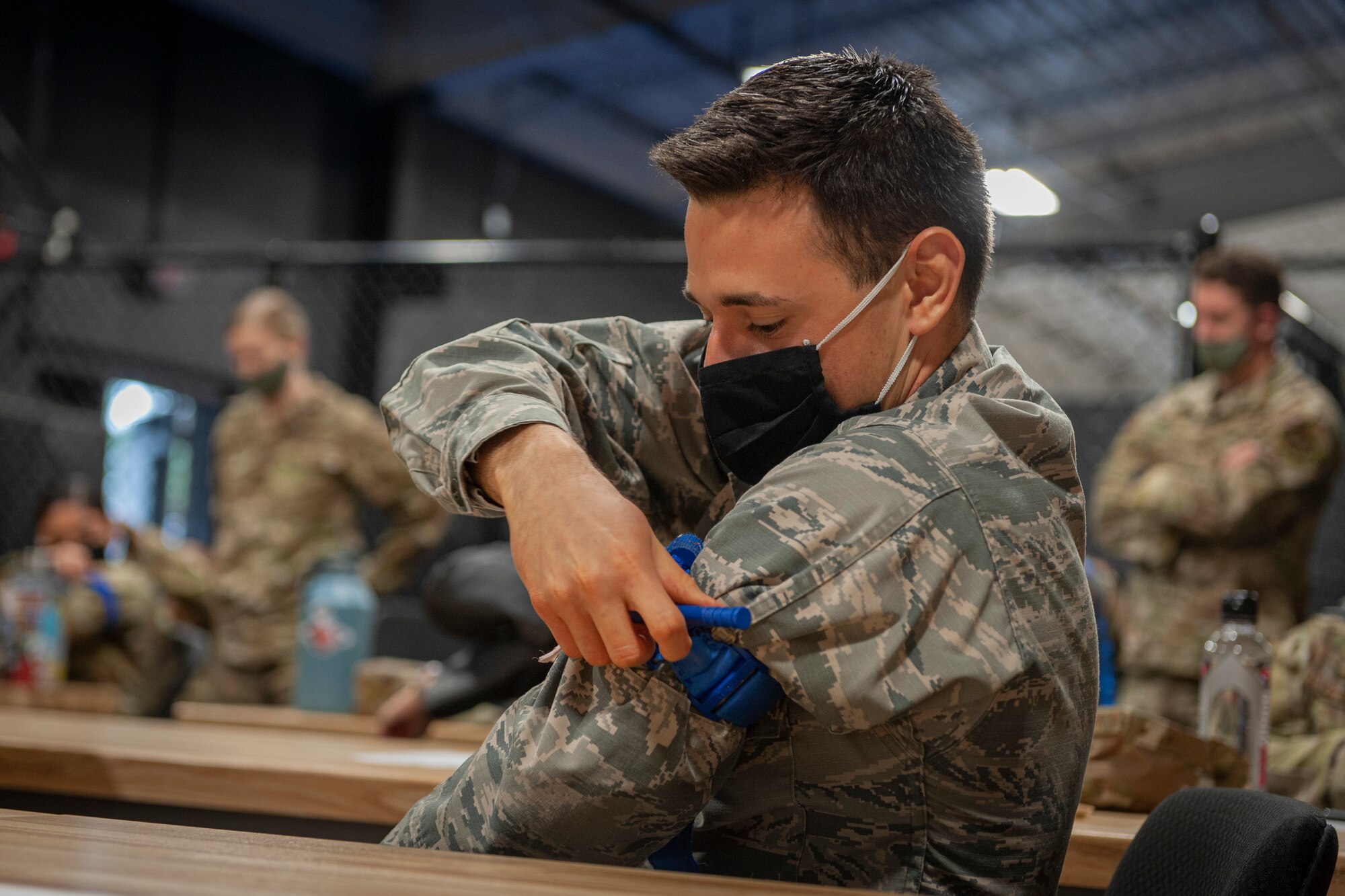 Photo of an Airman practicing applying a tourniquet