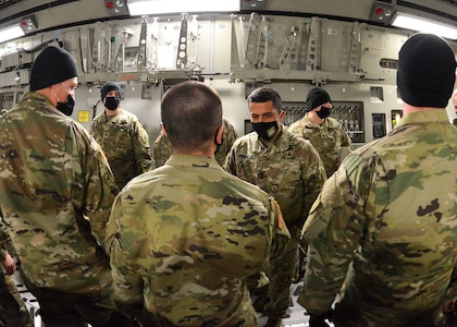 New Hampshire Adjutant Gen. David Mikolaities greets N.H. guardsmen at Pease Air National Guard base aboard a West Virginia National Guard C-17 Globemaster III aircraft upon their return from a week-long mobilization to Washington, D.C. on Jan. 23, 2021.