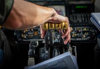 Hand on the throttle of a KC-135 aircraft.