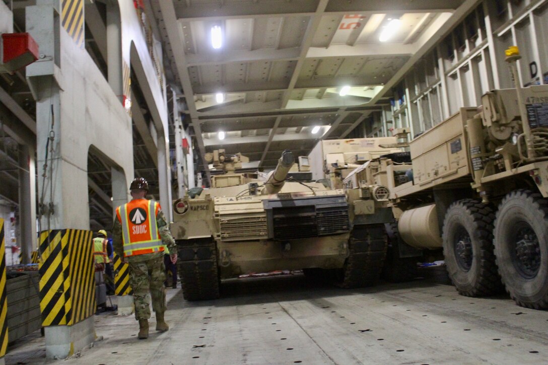 Capt. Christopher Lang, 1185th Deployment and Distribution Support Battalion, inspects the loading process aboard the Green Ridge at the Port of Shuaiba, Kuwait, Jan. 22, 2021.