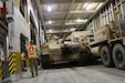 Capt. Christopher Lang, 1185th Deployment and Distribution Support Battalion, inspects the loading process aboard the Green Ridge at the Port of Shuaiba, Kuwait, Jan. 22, 2021.