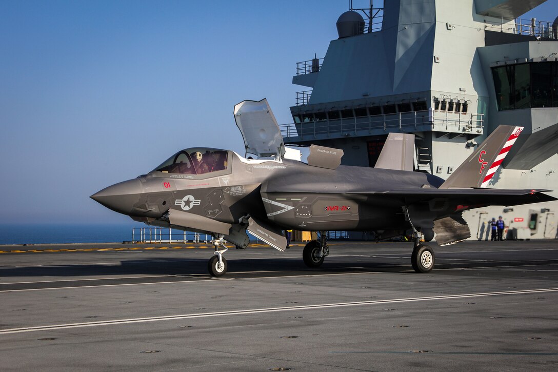 FIGHTER JETS ARRIVE ON HMS QUEEN ELIZABETH

PICTURED:A US F35-B COLOR BIRD WITH THE AIR CONTROL TOWER TO THE REAR.

Today F35-B fighter jets arrived on HMS Queen Elizabeth to take part in her exercise the way to North East Scotland.


HMS Queen Elizabeth has embarked two squadrons of F-35B stealth jets: the UK�s 617 Sqn and US Marine Corps fighter attack squadron 211.
With a total of fifteen F-35B�s and eight Merlin helicopters, it�s the largest air group to operate from a Royal Navy carrier in more than thirty years, and the largest air group of fifth generation fighters at sea anywhere in the world.
This month�s Group Exercise (GROUPEX) will see HMS Queen Elizabeth joined by warships from the UK, US and the Netherlands, which will accompany HMS Queen Elizabeth on her first global deployment in 2121.
However before then, the newly formed Carrier Strike Group will be put through its paces off the North East coast of Scotland as part of Joint Warrior, NATO�s largest annual exercise.