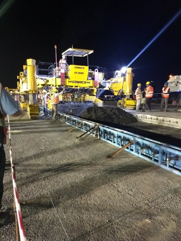 Contractors pave a runway during repairs at Ali Al Salem Air Base Kuwait. The project proved particularly challenging for the cost engineers from the U.S. Army Corps of Engineers Middle East District as extreme temperatures impacted the quality of the concrete.