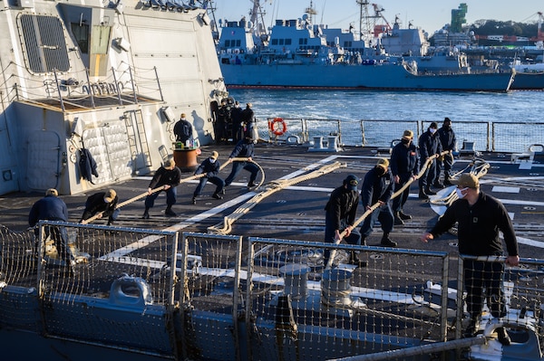 YOKOSUKA, Japan (Feb. 4, 2021) –  Sailors assigned to the Arleigh Burke-class guided missile destroyer USS Rafael Peralta (DDG 115) moor the ship as it arrives at Fleet Activities Yokosuka after completing a homeport change from San Diego, Calif., to join U.S. 7th Fleet. The forward presence of Rafael Peralta, a Flight IIA destroyer that can deploy with 2 MH-60 variant helicopters and also has improved ballistic missile defense, anti-air and surface warfare capabilities compared to its predecessor, enhances the national securi-ty of the United States and improves its ability to protect strategic interests. As the U.S. Navy's largest forward-deployed fleet, 7th Fleet employs 50-70 ships and submarines across the Western Pacific and Indian oceans. U.S. 7th Fleet routinely operates and interacts with 35 maritime nations while conducting missions to preserve and protect a free and open Indo-Pacific Region. (U.S. Navy photo by Mass Communication Specialist 2nd Class Reymundo A. Villegas III/Released)