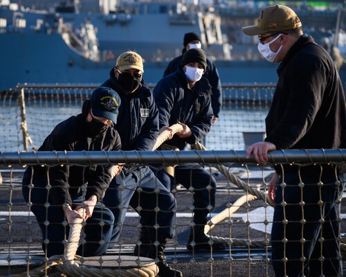 YOKOSUKA, Japan (Feb. 4, 2021) –  Sailors assigned to the Arleigh Burke-class guided missile destroyer USS Rafael Peralta (DDG 115) moor the ship as it arrives at Fleet Activities Yokosuka after completing a homeport change from San Diego, Calif., to join U.S. 7th Fleet. The forward presence of Rafael Peralta, a Flight IIA destroyer that can deploy with 2 MH-60 variant helicopters and also has improved ballistic missile defense, anti-air and surface warfare capabilities compared to its predecessor, enhances the national securi-ty of the United States and improves its ability to protect strategic interests. As the U.S. Navy's largest forward-deployed fleet, 7th Fleet employs 50-70 ships and submarines across the Western Pacific and Indian oceans. U.S. 7th Fleet routinely operates and interacts with 35 maritime nations while conducting missions to preserve and protect a free and open Indo-Pacific Region. (U.S. Navy photo by Mass Communication Specialist 2nd Class Reymundo A. Villegas III/Released)